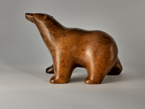 Photo of a a small, smooth soapstone carving of a grizzly bear by Greg Tomkins.