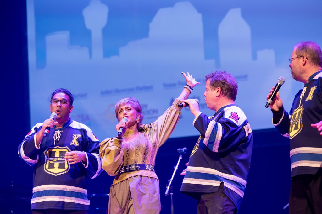 Mayor Jyoti Gondek singing onstage with the Heebee-jeebees at the 2023 Celebration for the Arts.