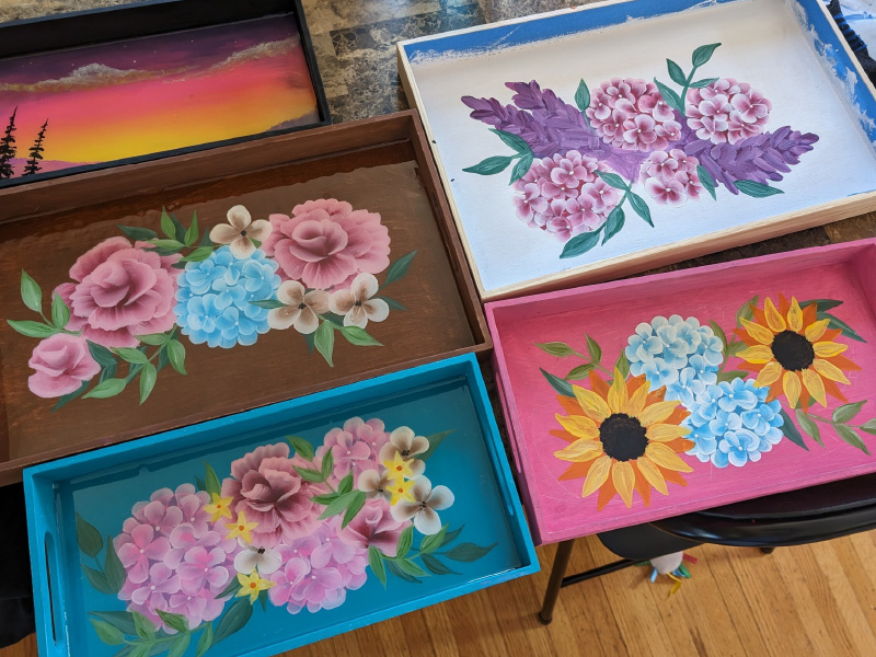 Trays with floral artwork painted on them