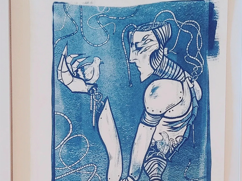 Blue and white artwork of a woman holding a bird by Soup Davis