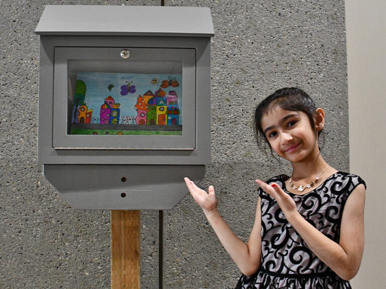 Hareet Ranu with her Northeast Mini Gallery artwork My Colourful Neighbourhood