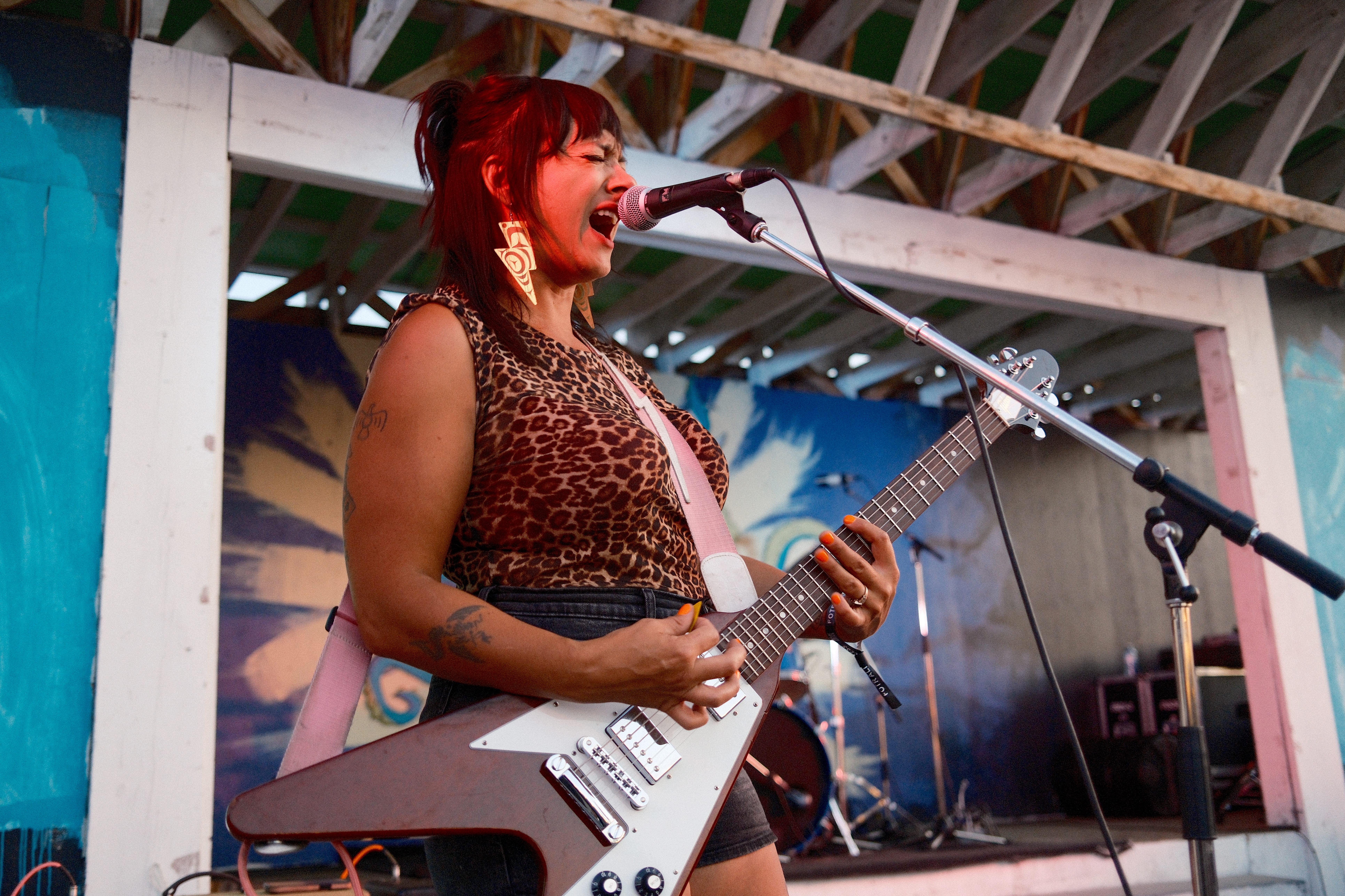 Photo of Miesha Louie playing electric guitar on stage