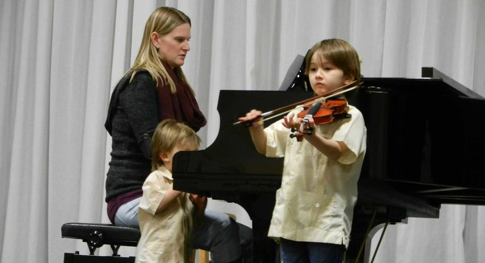 Photo of violin and music lessons being conducted to kids by Kirstin Flores