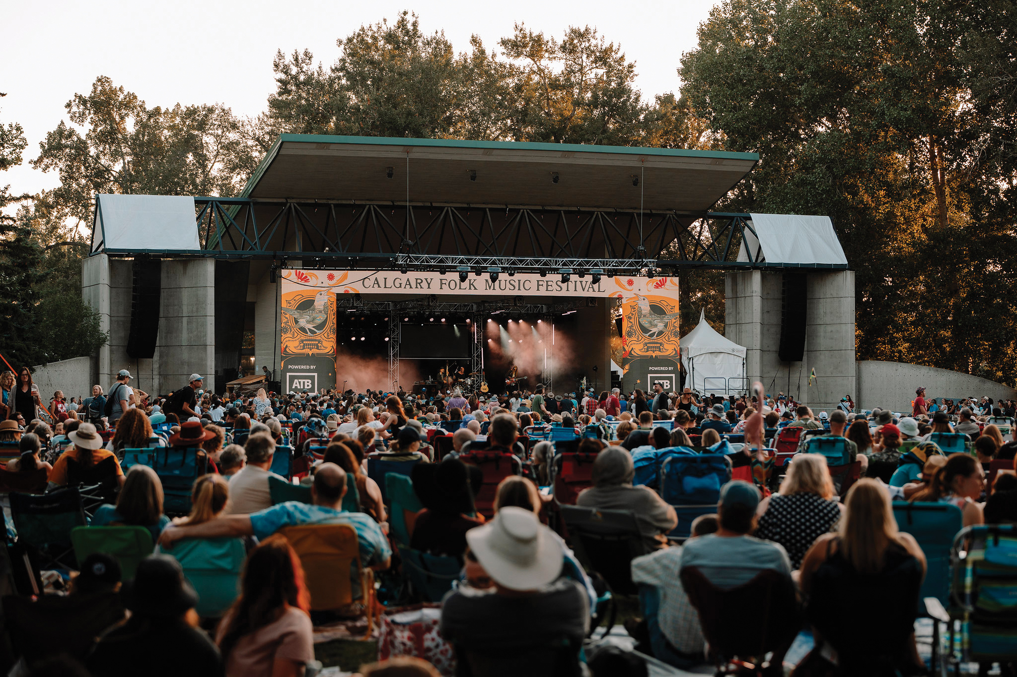 A photo from behind the crowd gathered in front of the stage of the Calgary Folk Music Festival.