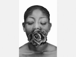 A black-and-white hyperrealist drawing of a person with a flower in their mouth, by Alexander Akhere Oriaifo