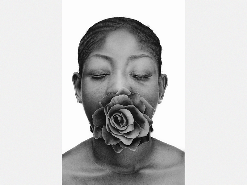 A black-and-white hyperrealist drawing of a person with a flower in their mouth, by Alexander Akhere Oriaifo