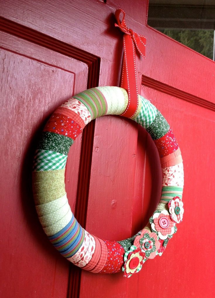 Photo of a decorative holiday fabric wreath hanging on a door