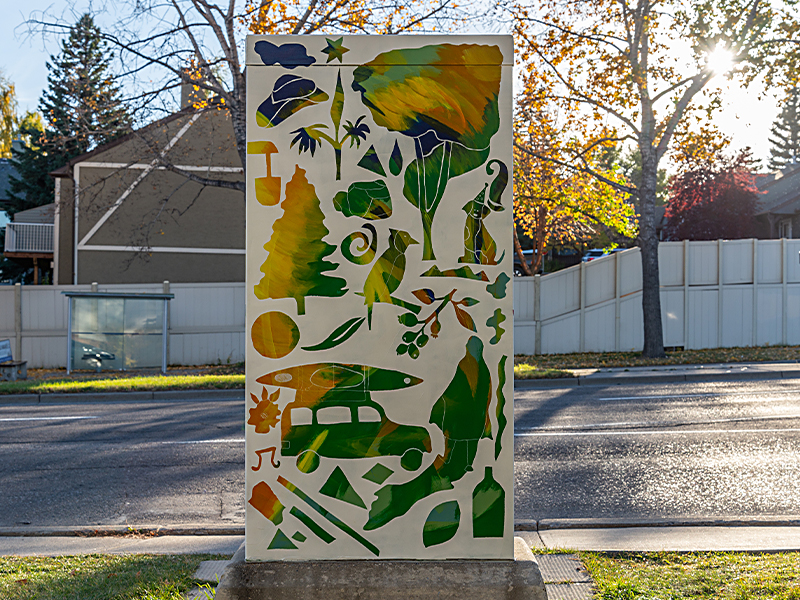 A utility box painted with colourful wildlife and nature silhouettes.