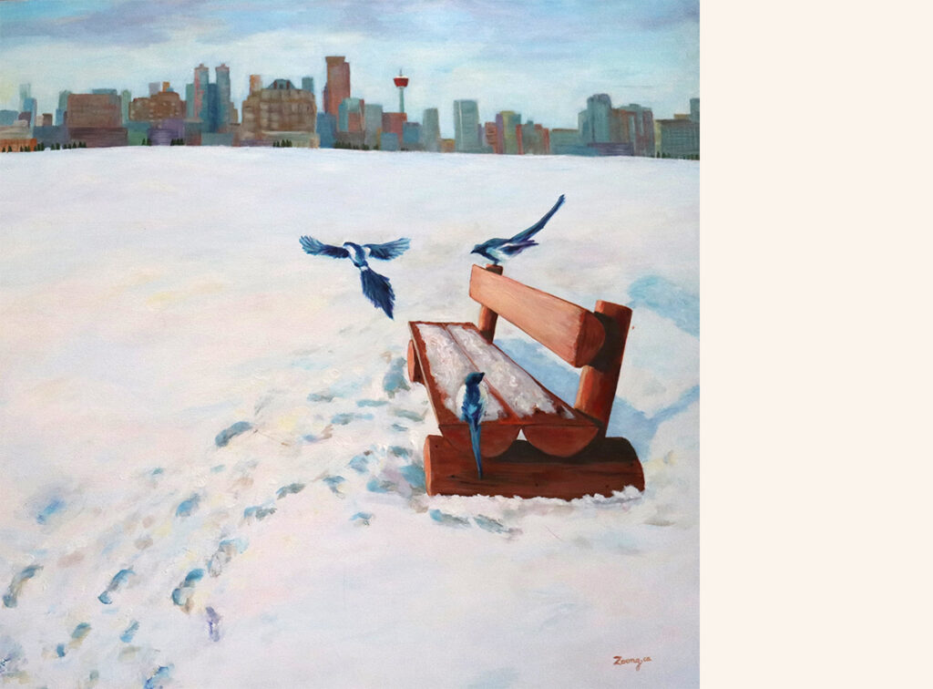 A snow-covered bench overlooking Calgary's skyline. Three birds hover around the bench.
