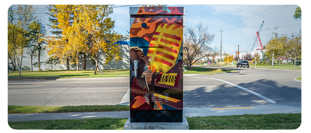 A utility box painted with a colourful design of a person singing into a microphone.