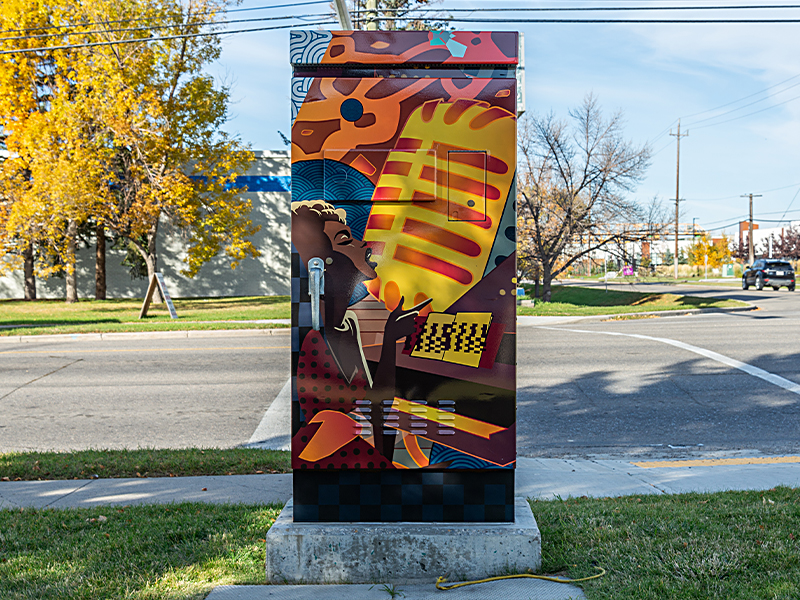 A utility box painted with a colourful design of a person singing into a microphone.