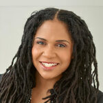 Melanee Murray-Hunt headshot, smiling against a light grey background