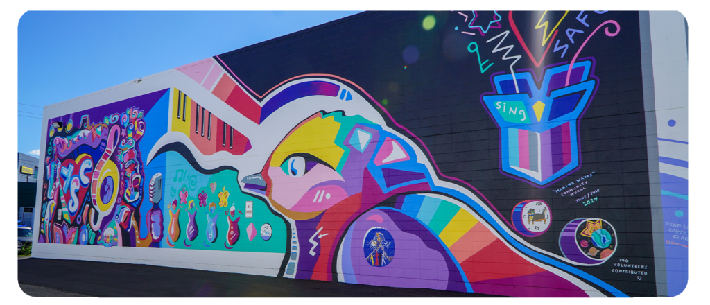 Colourful mural with a bird, musical notes, and a "Home Safe" message in bold shapes.