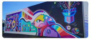 Colourful mural with a bird, musical notes, and a "Home Safe" message in bold shapes.