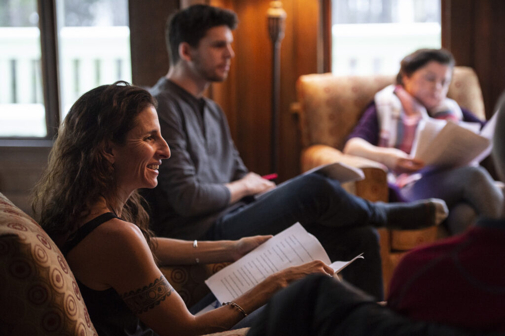 Attendees of the Mountain Wilderness Writing Workshop from 2018 sitting in comfortable chairs gathered in discussion
