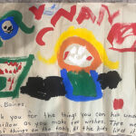 A colourful painted picture by children with the copy: To Mr. Baines, Thank you for the things you can hide under the pillow as you make two wishes. There were lots of things on the table. All the kids liked it.