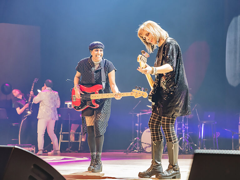 Mayor Gyoti Gondek (right) with Lisa Jacobs (left) both playing bass guitar on stage at the 2025 Celebration for the Arts