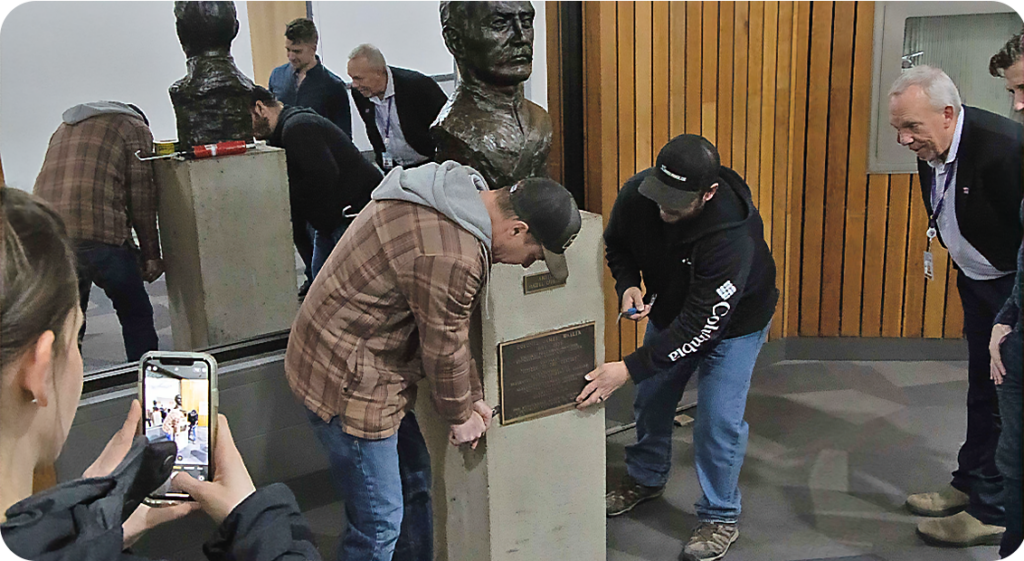 Workers prizing the bronze plack away that holds the time capsule