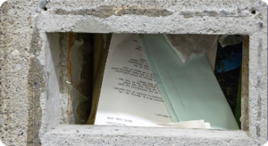 The time capsule open with documents and letters showing at the top