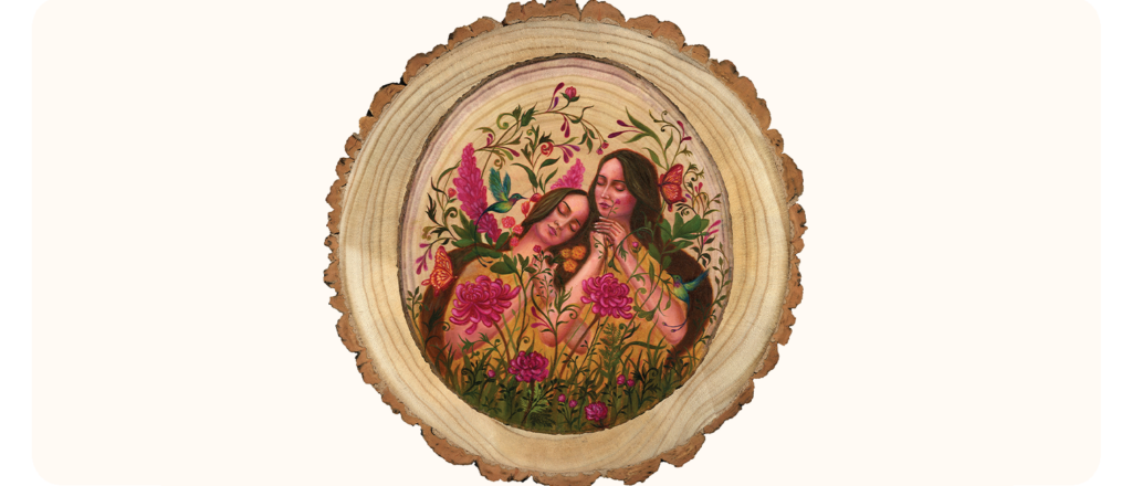 A circular painting on a wood slice featuring two women surrounded by vibrant pink flowers, butterflies, and birds. The women have calm expressions, eyes closed and are nestled closely together.