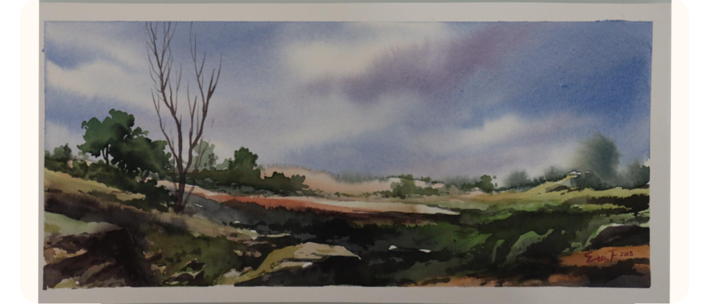 A watercolour landscape painting of a wide-open field with rocky terrain and sparse greenery. A few tall, bare tree branches rise on the left, while clusters of green trees appear in the distance under a vast sky filled with soft purple and blue clouds. Signed in the corner with "Ensieh 2013."
