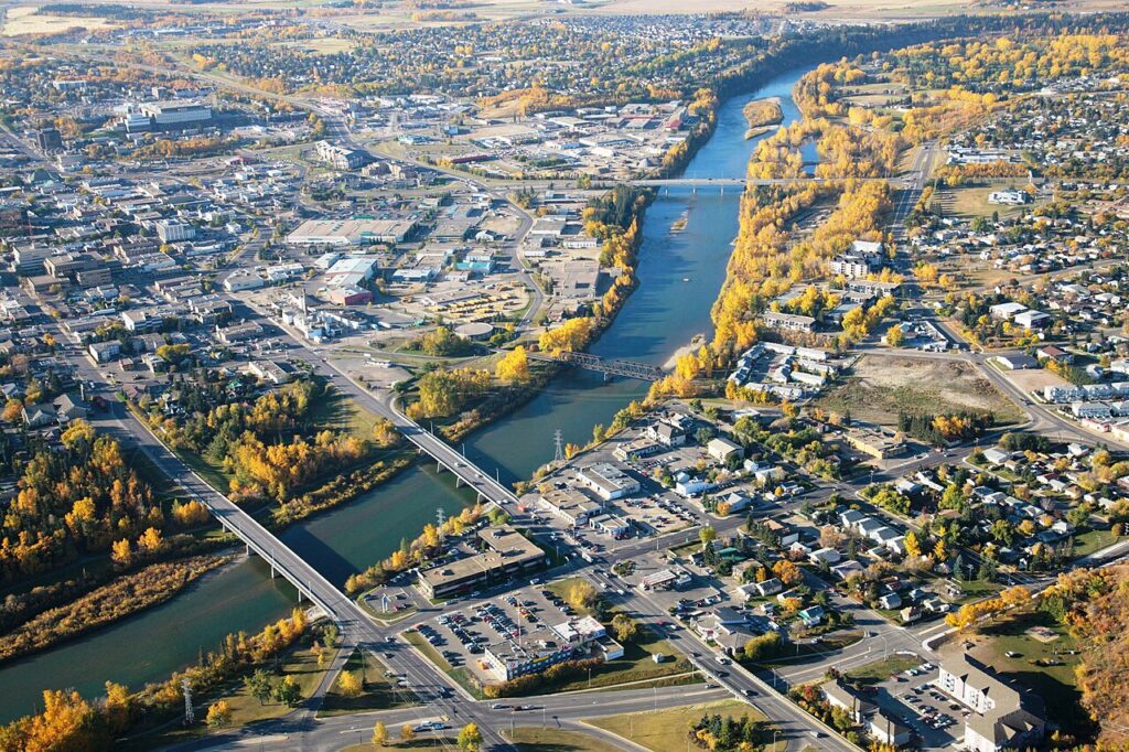 An aerial view of the city of Red Deer, Alberta, with bridges prominently located in the centre of the image
