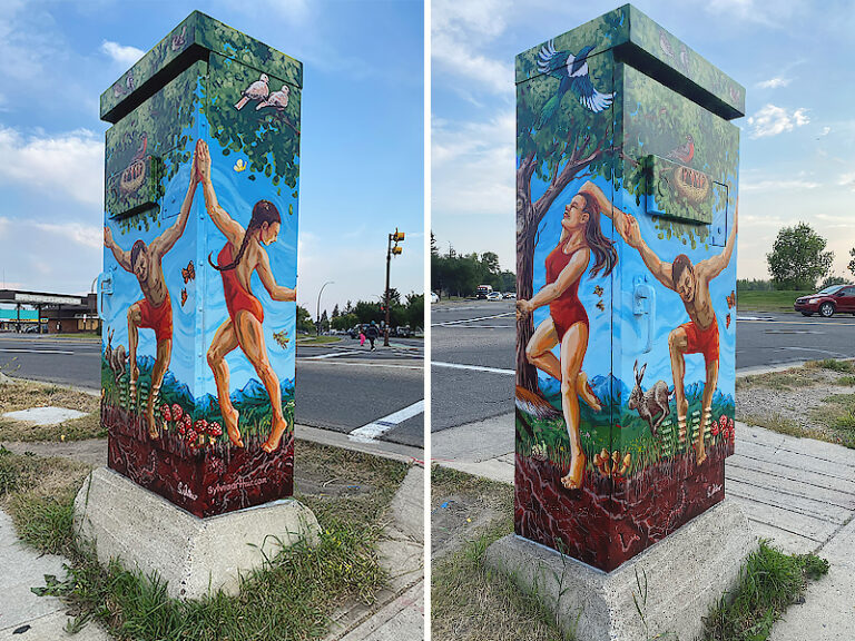 A painted utility box shows two people in red swimsuits reaching out to each other in an outdoor setting, with trees, animals and birds surrounding them.