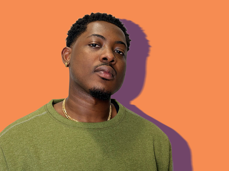 Portrait shot of Collins Amegah with an orange background