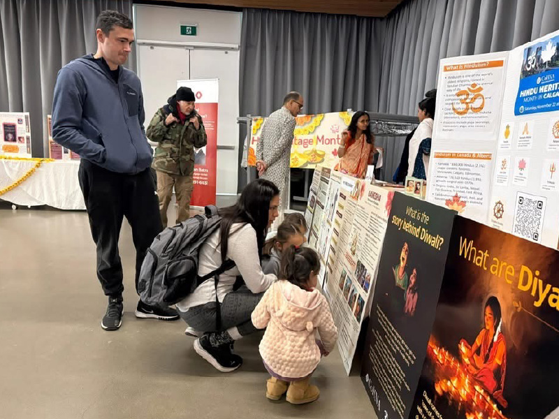 Family crouches down to look at informational displays
